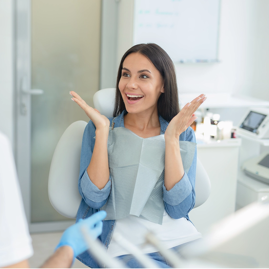 woman gesturing near dentist talking to her in clinic