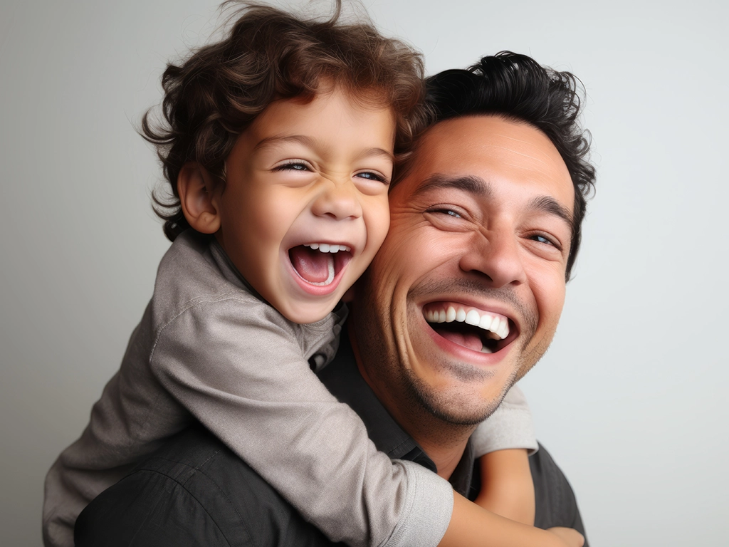 happy father with his son on grey background_LG