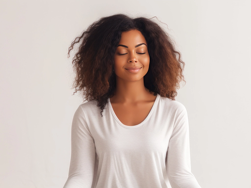 portrait of attractive peaceful young woman meditating indoors_LG