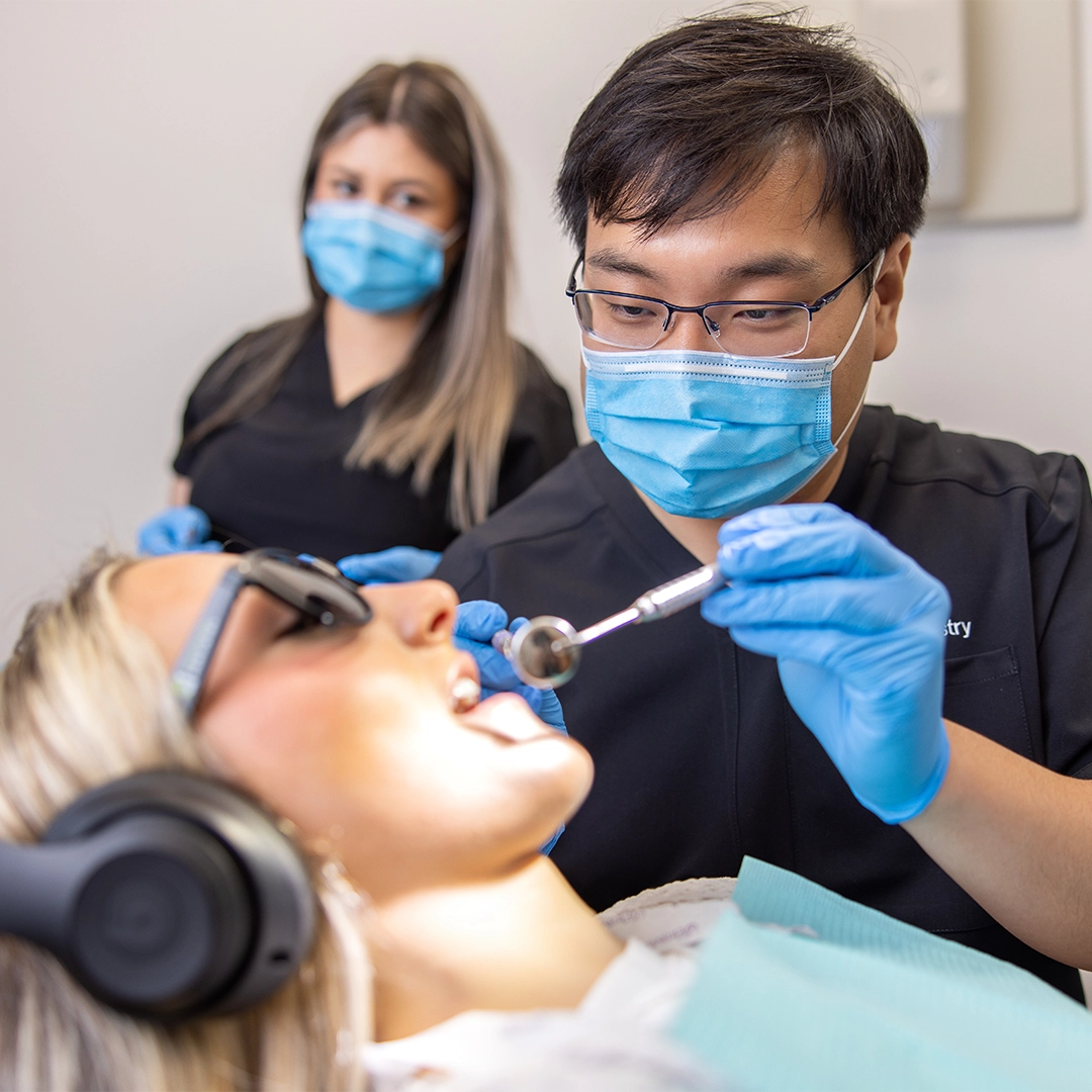 doctor chen and assistant examining a comfortable patient