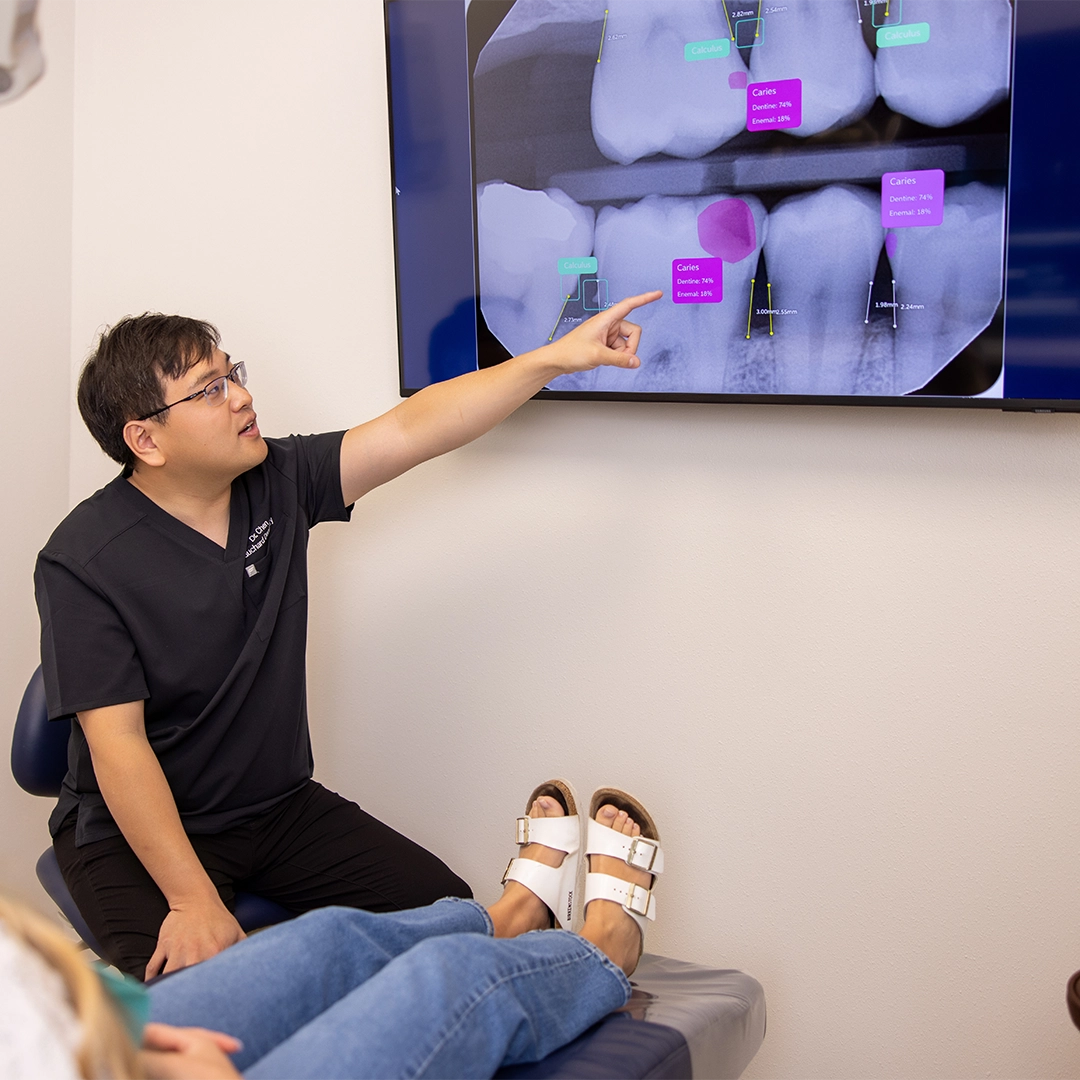 fauchard dentistry dr chen explaining digital xrays to a patient during treatment