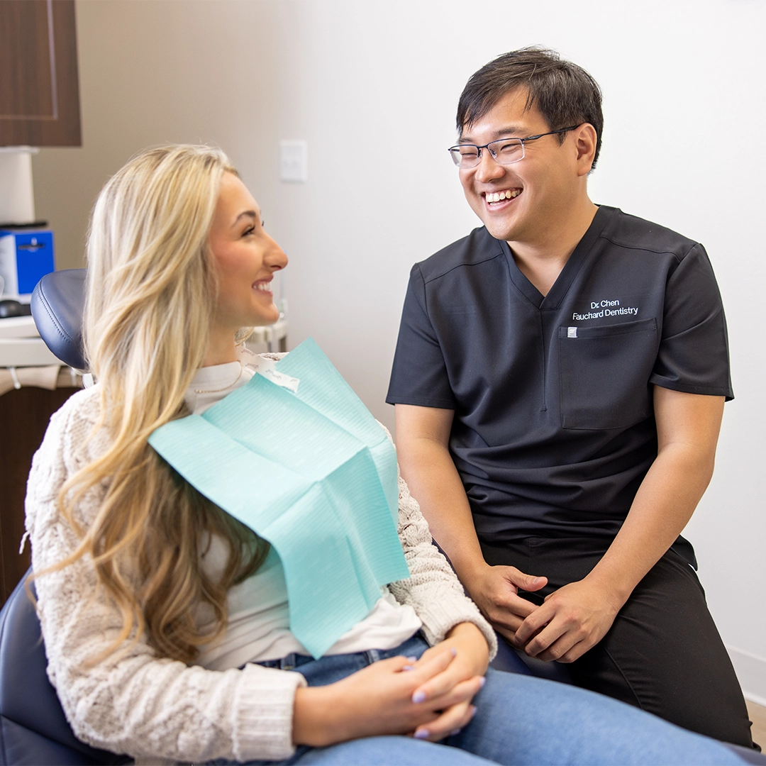 fauchard dentistry dr chen talking pleasantly with patient during treatment