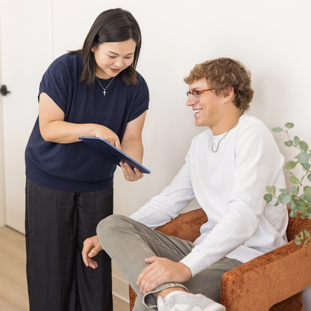 fauchard dentistry front desk checking in a patient on an ipad